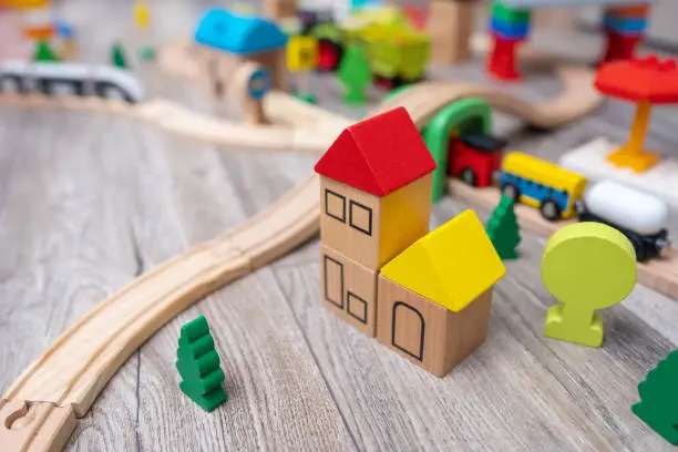 Photo of Close-up of the colorful kids toy town with a railroad. Wooden toys
