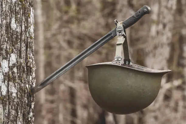 Vintage M1 army helmet hanging on bayonet