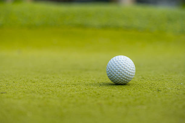 istock White golf ball on green fake grass.. 1481229047
