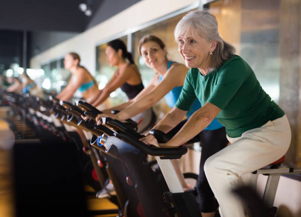 istock Mature woman taking cycling class at gym 1481229449