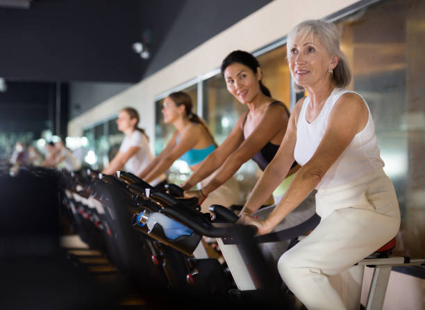 istock Mature woman taking cycling class at gym 1481229514