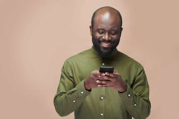 istock Man reading message on the phone and smiling 1481231377