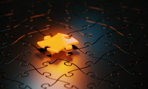 istock Orange Jigsaw Puzzle Piece Glowing On Black Background 1481232583