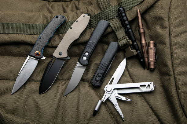 istock Penknives, multi-tools and tactical pens. Folding pocket knives on a khaki background. 1481235956