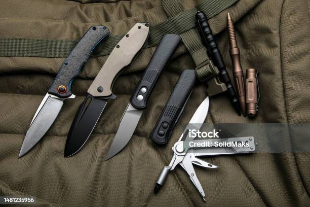 Penknives Multitools And Tactical Pens Folding Pocket Knives On A Khaki  Background Stock Photo - Download Image Now - iStock