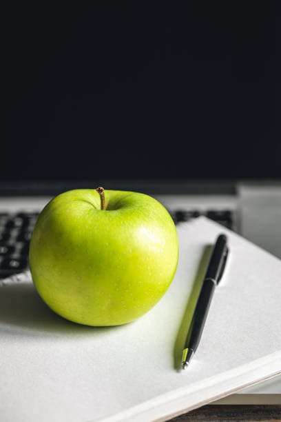 istock Apple near laptop at workplace, healthy snack. 1481238398