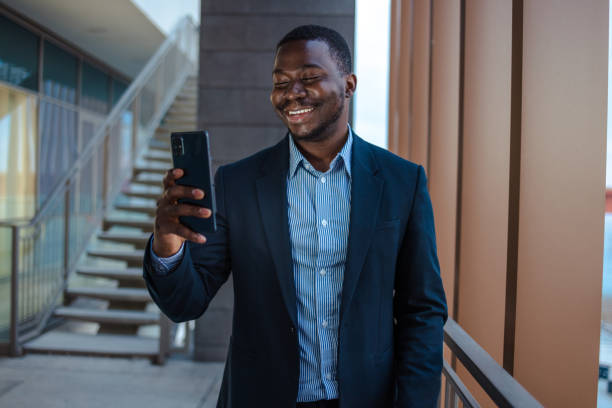 istock Cheerful African-American man using smart phone for communication 1481238636