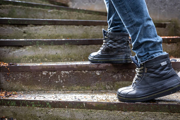 istock A man in boots on the old steps, close-up. 1481238714