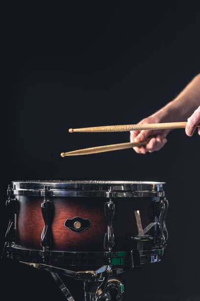istock A man plays the snare drum against a dark background. 1481240979