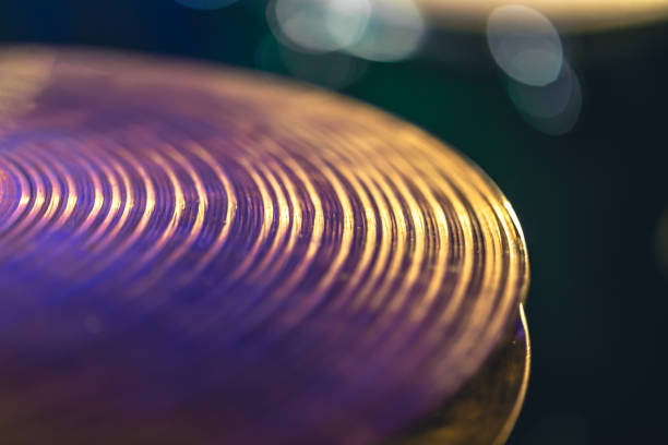 Drum cymbal close-up on a dark blurred background, music concert concept, percussion instrument.