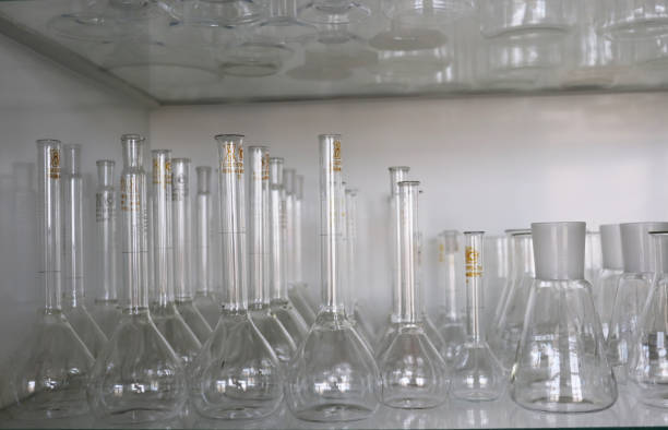 photo set of glass flasks on a shelf in a cabinet of a chemical laboratory