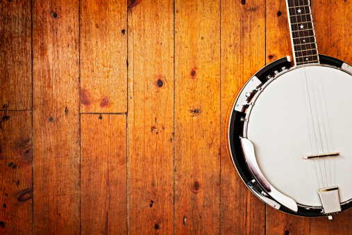 Five-string bluegrass banjo on distressed wooden planks. Camera: Canon EOS 1Ds Mark III.