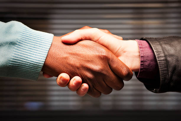 Black-white handshake Interracial handshake. Camera: Canon EOS 1Ds Mark III. apartheid stock pictures, royalty-free photos & images