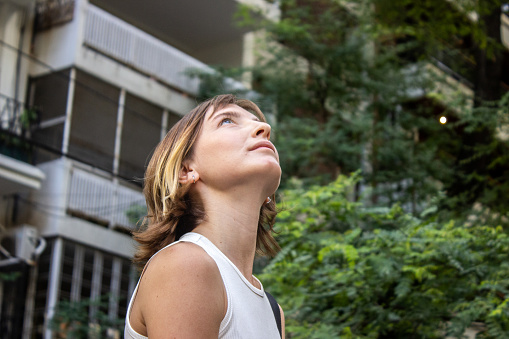 Young woman walking and looking away outdoors