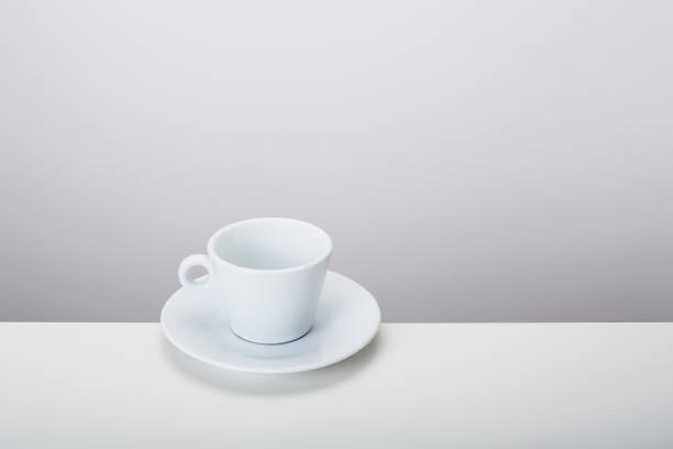 istock White porcelain mic espresso coffee cup with saucer on white background, soft shadow 1481241884