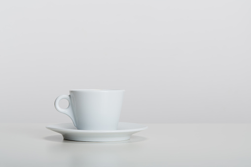 White porcelain mic espresso coffee cup with saucer on white background, soft shadow