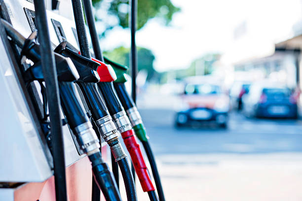 Gas pumps Gas station with out-of-focus car approaching. Camera: Canon EOS 1Ds Mark III. small group of objects stock pictures, royalty-free photos & images