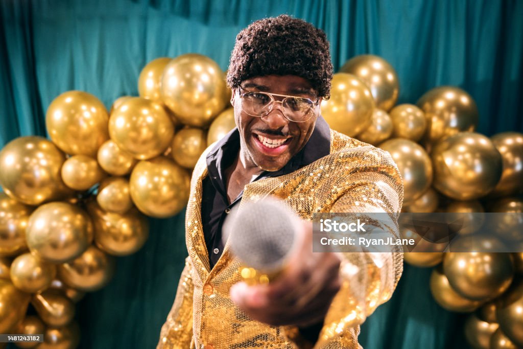 Retro Television Gameshow Broadcast Host A fun depiction of a competitive TV game show, stylized in late 1970's or early 1980's fashion.  The host, an African American man in a stunning gold blazer, talks to the crowd and the television. Trivia Stock Photo