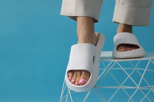 istock Woman wearing comfortable rubber slippers on light blue background, closeup. Space for text 1481246131