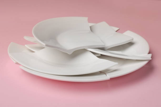 istock Pieces of broken ceramic plate on pink background, closeup 1481247212