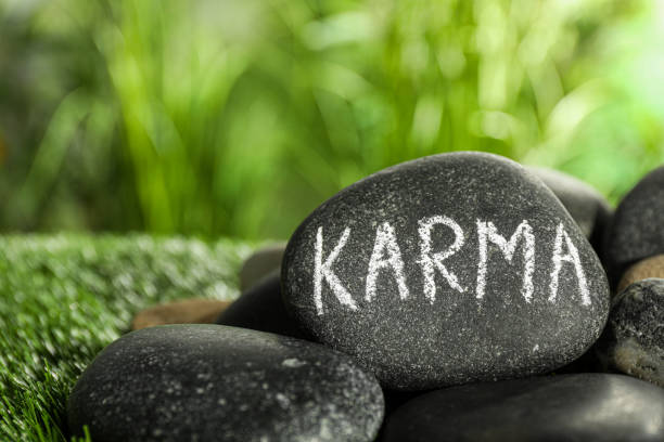 istock Stones with word Karma on green grass, closeup. Space for text 1481247290