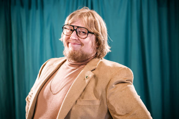 Vintage looking Caucasian man with late 1970's or early 1980's fashion styling. Turtleneck with a blazer and gold chain.