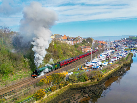 A North Yorkshire Moors Railway operated Steam train departs Whitby to Pickering along the Esk Valley line. 8th April 2023.