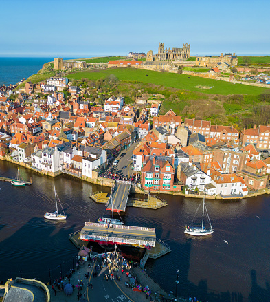 Whitby Swing Bridge opens up at High Tide to enable the Boats to return into Whitby Harbour. Aerial Image. 8th April 2023.