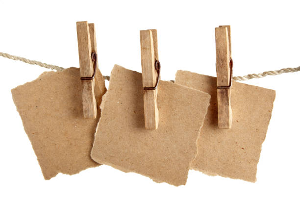 istock Craft note paper pinned with a vintage clothespin on a rope on a white background 1481249515