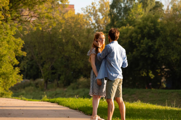 istock Young couple standing near each other and hugging 1481250394