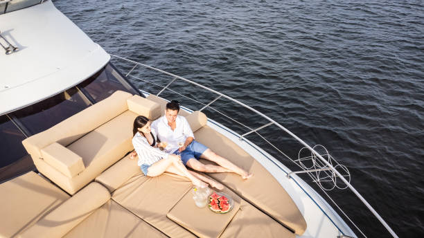 istock Young couple embracing on a yacht 1481250525