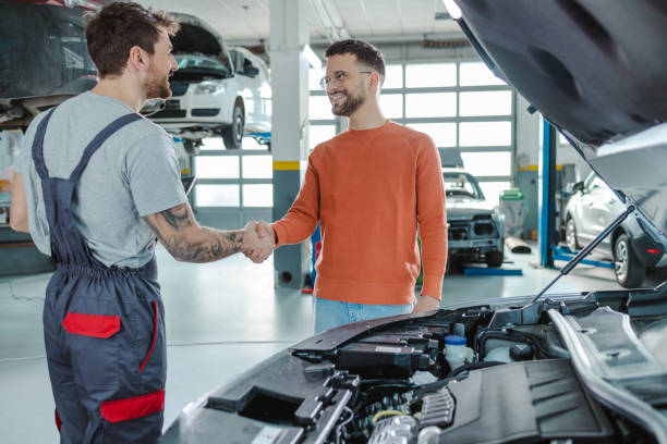 istock Satisfied customer and the auto mechanic shake hands 1481250662