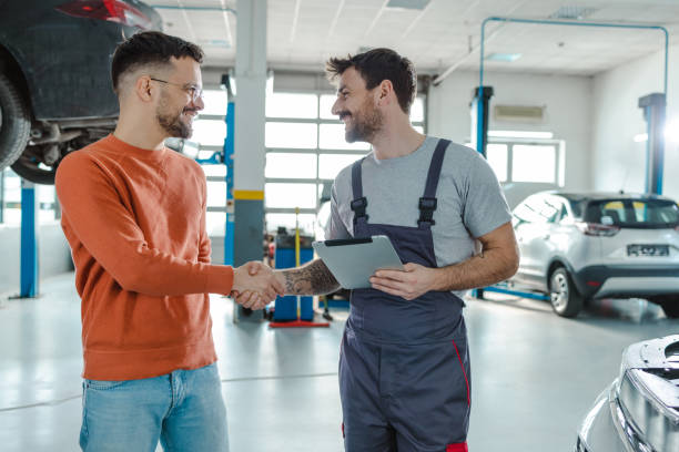 istock Young man shaking hands with car mechanic 1481251260
