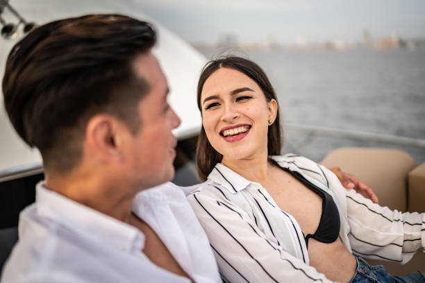 istock Young couple embracing and talking on a yacht 1481251709