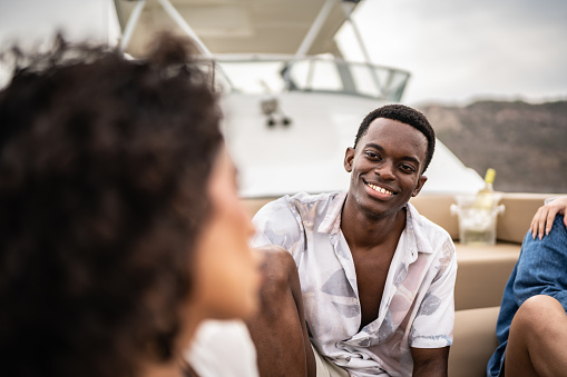 Happy young man talking during a yacht trip