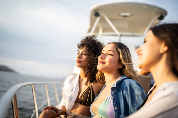 Young women relaxing and contemplating on a yacht