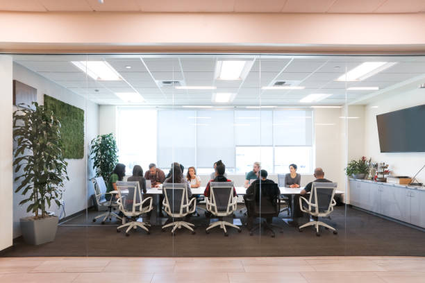 istock Diverse Group Of People Talking To Each Other On a Board Table 1481252755