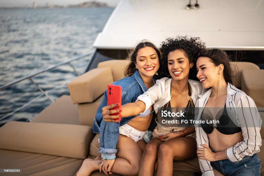 Group of friends taking a selfie during a yacht trip 20-24 Years Stock Photo