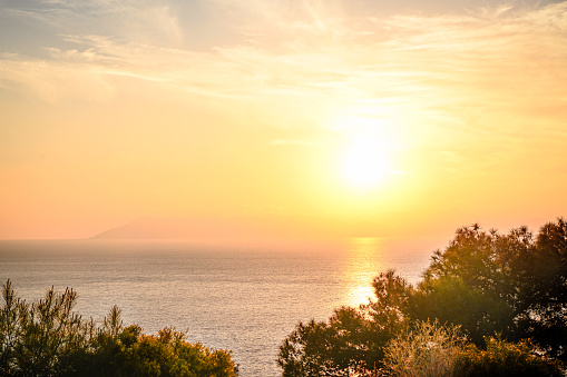 sunset over sea and mountain landscape