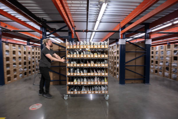 istock Bearded White Man Holding Shelf In a Fulfillment Center 1481252824