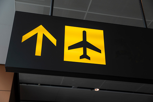 Check in to your plane sign to gate at the Airport - travel and tourism theme concept.
