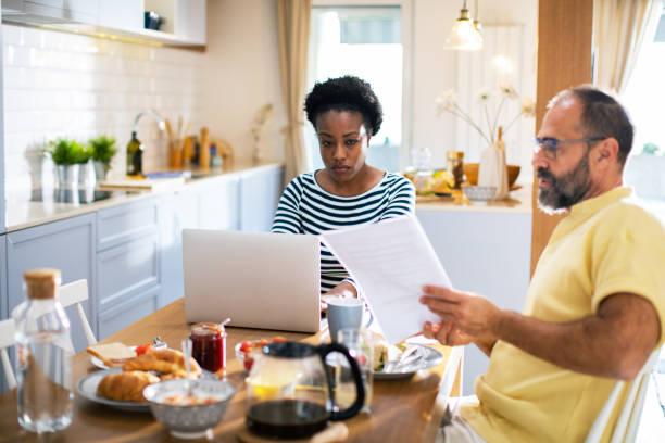 istock Mid adult couple going over their home finances during breakfast 1481255800