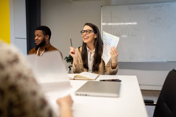 istock Smiling business people sharing document in meeting 1481256026