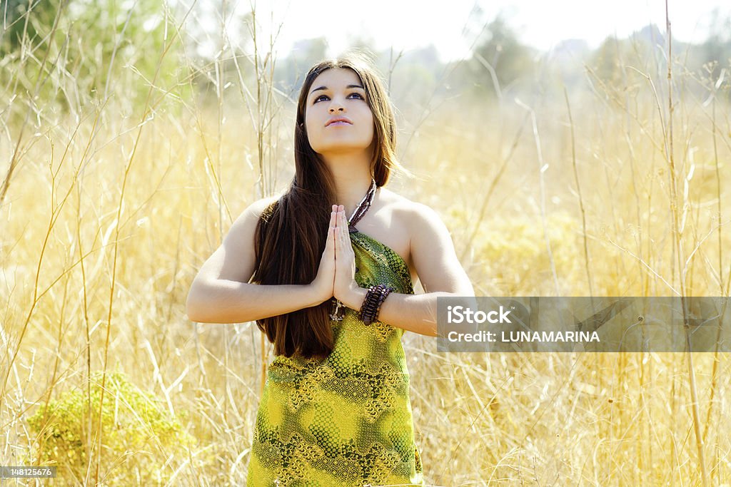 Prier mains de femme indienne asiatique dans un champ doré - Photo de 20-24 ans libre de droits