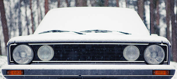 Frontal close-up of an old car in the snow