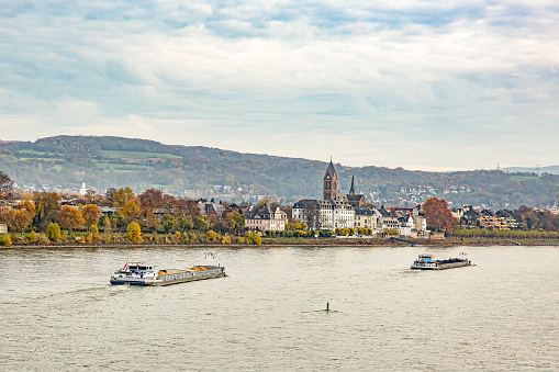 Two cargo ships on the river Rhine with the castle and the curch of Neuwied Engers in the background