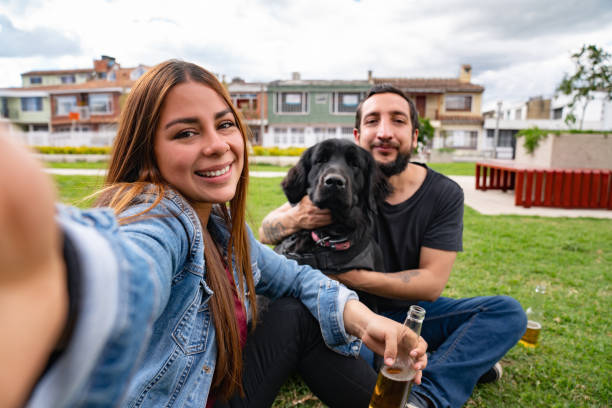 istock Happy couple taking a selfie while having fun on a date with their dog 1481260084