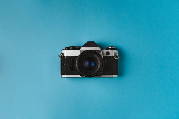 istock Retro film camera on blue background 1481260830