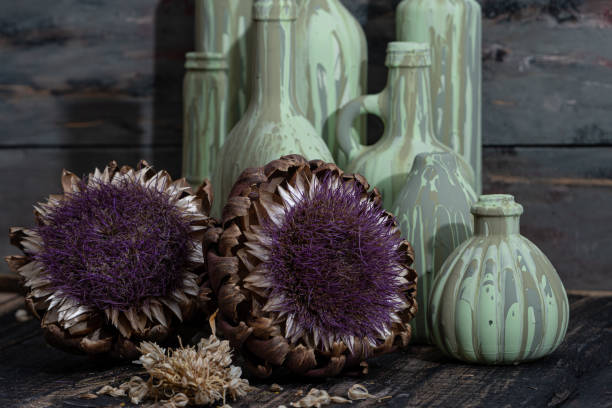 beautiful dried lilac flowers on rustic table next to ceramic vases