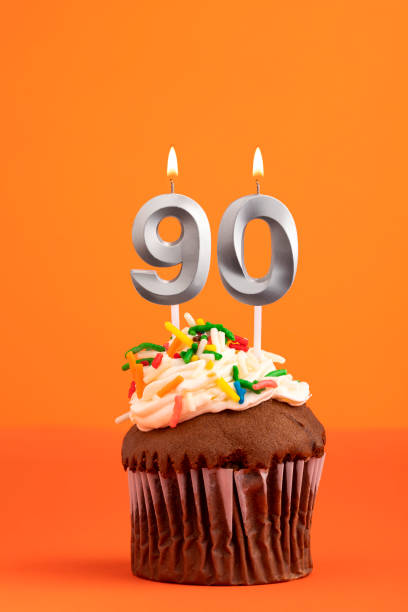 istock Candle number 90 - Cake birthday in orange background 1481264253